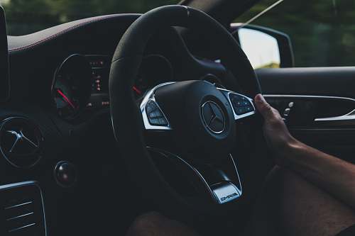 steering wheel person holding on black steering wheel inside car transportation